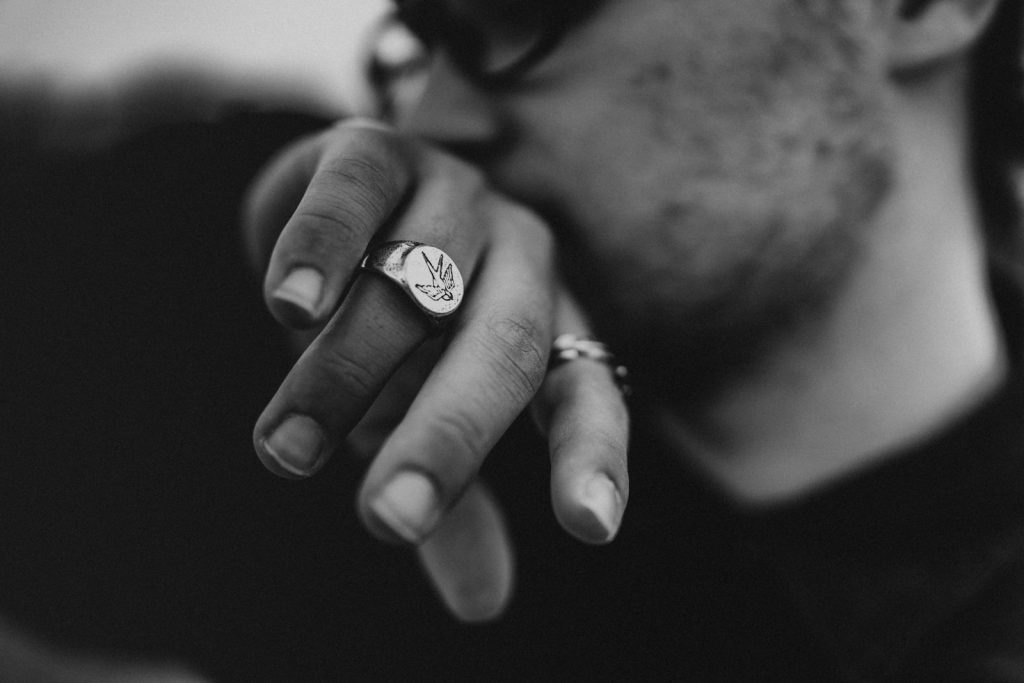 grayscale photo of man and woman wearing rings